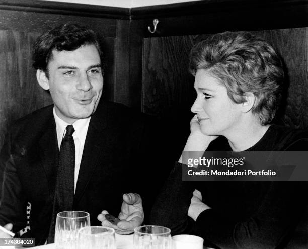 Gian Maria Volontè and Carla Gravina seated together at a dinner; the two actors are lovers and they have a daughter named Giovanna. Milan , March...