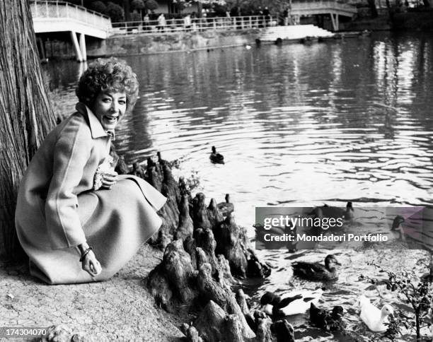 The Italian film, theatre and television actress Lauretta Masiero is laughing while she is feeding the ducks of the lake of Margherita Gardens in...