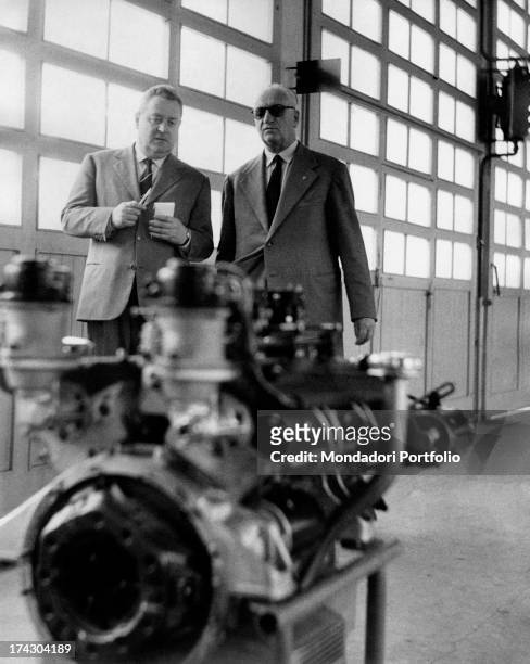 Ezio Colombo interviews the manufacturer Enzo Ferrari in a Maranello establishment in front of a Ferrari engine. Modena , May 1960