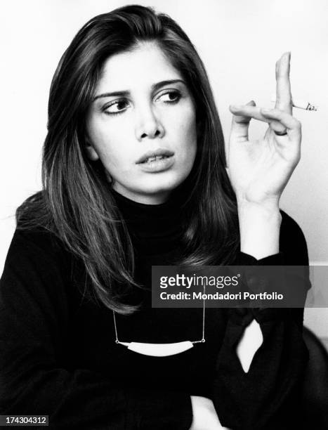 Italian actress Laura Belli smoking a cigarette. 1974.