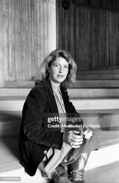 Italian writer and journalist Barbara Alberti sitting on a staircase. 1970s.