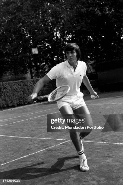 Italian tennis player Adriano Panatta getting ready to reply with a backhand stroke playing tennis. 1960s.