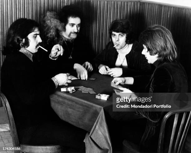 The Italian music band I Camaleonti playing cards in a cafè in Milan: from left Paolo de Ceglie , Livio Macchia , Antonio Cripezzi known as Tonino ,...