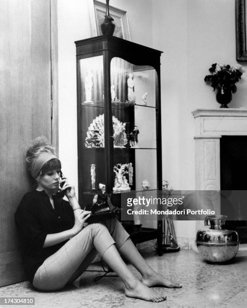 Annette Susanne Str¯yberg, the Danish movie actress, absorbed in reading Oedipus the King, by Sophocles, while smokes a cigarette; Str¯yberg began...
