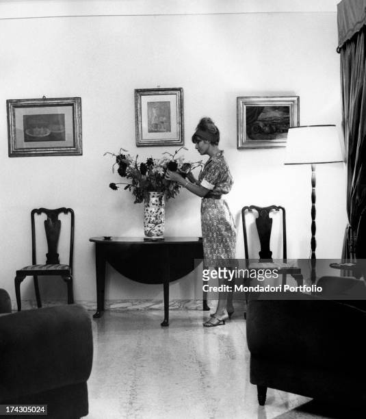 The Danish cinema actress Annette Susanne Str¯yberg, married to the director Roger Vadim, swigging a drink in the kitchen of her Roman house. Rome ,...