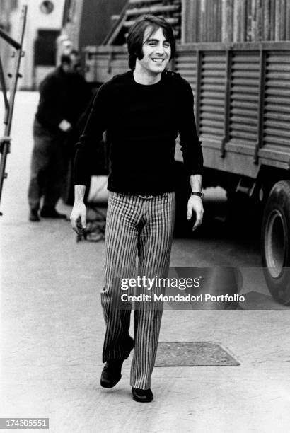 French singer Michel Delpech walking smiling. Milan, 1970.