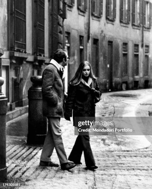 The Italian actress Valeria Ciangottini is crossing a street of Milan with her boyfriend, the journalist Fabrizio Ricci; the actress was the young...