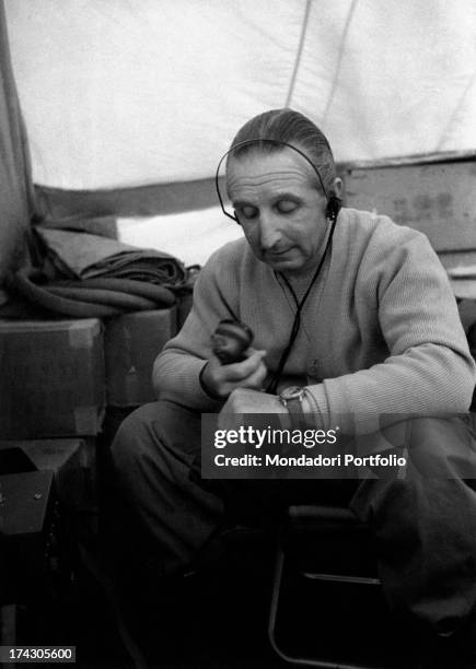 Italian explorer and geologist Ardito Desio, member of CAI and director of the Geology Department at the University of Milan, sitting in a tent at...