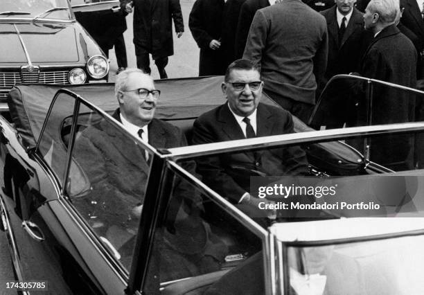 President of the Italian Republic Giuseppe Saragat sitting on board a car beside the Knight of Merit for Labour and President of the factory Giovanni...