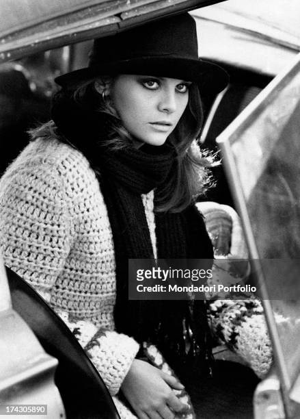 Italian actress Silvia Dionisio opening a car door in My Friends. Florence, 1975.