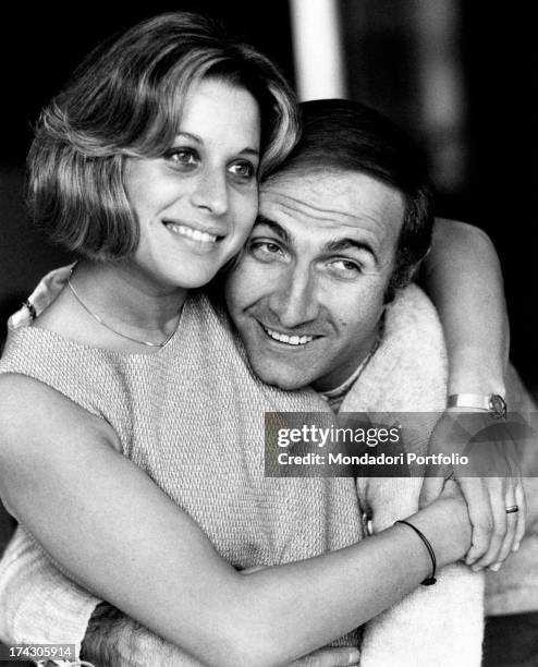 Italian TV presenter Pippo Baudo and his wife Angela Lippi hugging each other. Milan, 1970.