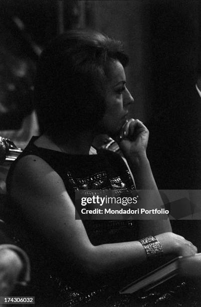 Close-up of the profile of the Chilean singer Matilde Urrutia, third wife of the Chilean poet Pablo Neruda , seated next to her husband during a...