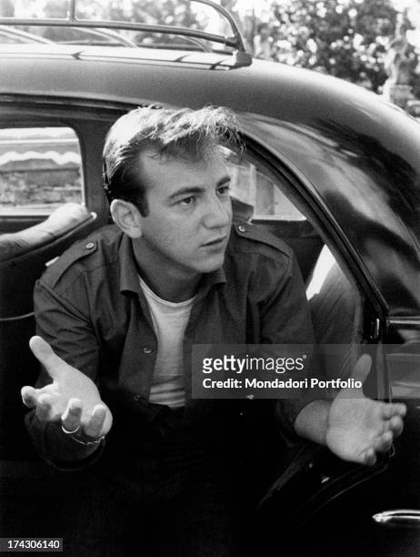 American singer and actor Bobby Darin gesticulating on board a car. August 1960.