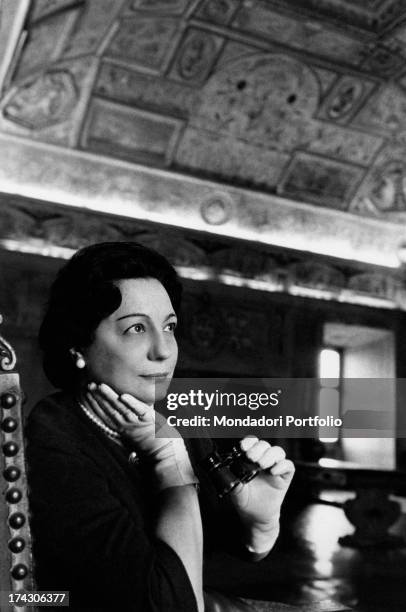 Italian writer and translator Maria Bellonci watching the ceiling of a hall of Castel Sant'Angelo. Rome, 1961.