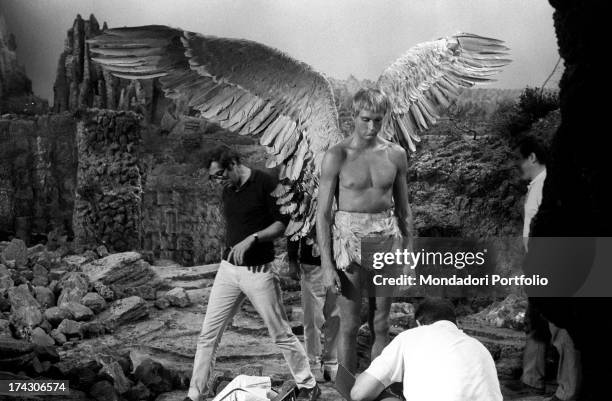 The American actor John Phillip Law gets his costume adjusted by the workers of the troupe during a pause from the filming of Barbarella, where he...