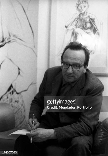 The Italian neorealist writer Vasco Pratolini, author of works such as Cronaca familiare , Cronache di poveri amanti and Metello , is posing in front...
