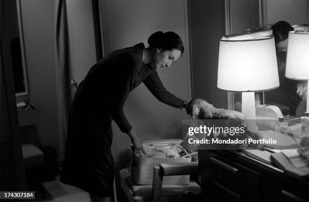 The Italian actress Paola Mori, born the countess Paola Di Girifalco, the third wife of the US film director Orson Welles, arranges the items in her...