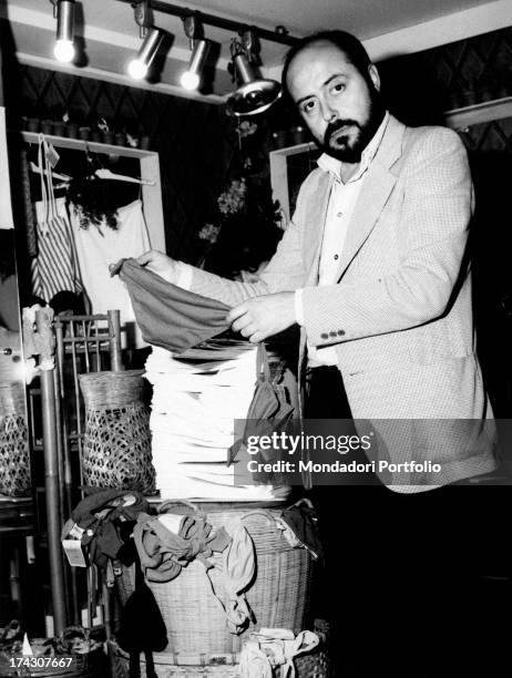 The Italian stylist Elio Fiorucci is inside one of the homonymous boutiques he owns, showing a thong. Milan , 1974..