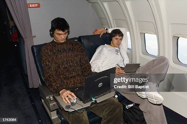 Yao Ming and Bostjan Nachbar of the Houston Rockets relax on the team airplane on December 1, 2002 in Sacramento, California. The Kings won 103-84....