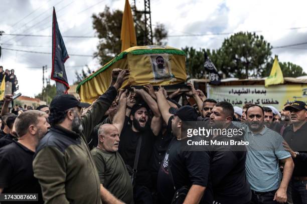 Hezbollah supporters carry the coffin of a Hezbollah militant killed yesterday during clashes against IDF in the southern border of Lebanon on...