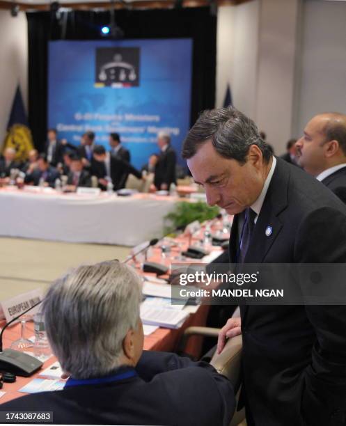 Banca d'Italia Governor Mario Draghi chats with President of the European Central Bank Jean-Claude Trichet as they prepare for the meeting of the G20...