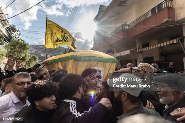 Hezbollah supporters carry the coffin of a Hezbollah militant killed yesterday during clashes against IDF in the southern border of Lebanon on...