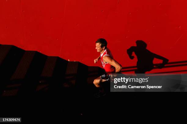 Jude Bolton of the Swans runs up the players race during a Sydney Swans AFL training session at Sydney Cricket Ground on July 24, 2013 in Sydney,...