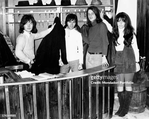 The four members of the Shocking Blue take the coats at the wardrobe's desk of a restaurant; the Dutch rock band reached number one in U.S. Chart...