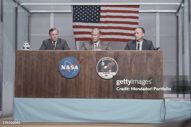 American astronauts Neil A. Armstrong, Edwin E. 'Buzz' Aldrin, and Michael Collins take questions during a press conference just under two weeks...