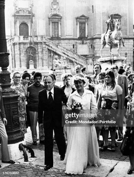 Italian singer and actor Claudio Villa going in Campidoglio walking arm in arm with his bride-to-be Patrizia Baldi. Rome, 18th July 1975.