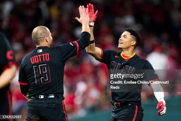 Joey Votto high fives Noelvi Marte of the Cincinnati Reds during a game against the Pittsburgh Pirates at Great American Ball Park on September 22,...