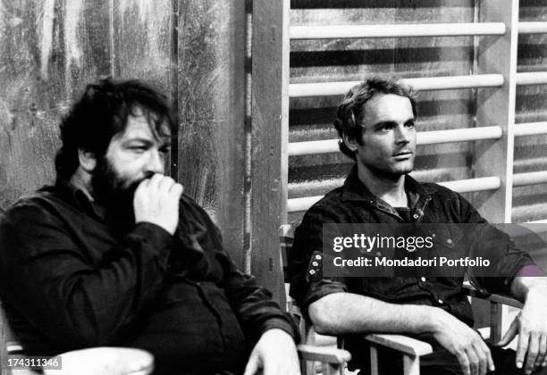 Italian actor Terence Hill sitting beside Italian actor Bud Spencer in the film Watch Out, We're Mad!.. Rome, 1974.