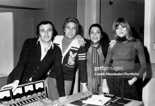 Italian singers Marina Occhiena, Angela Brambati, Angelo Sotgiu and Franco Gatti posing in a recording studio. They form the band Ricchi e Poveri....