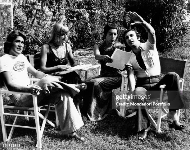 Italian singers Marina Occhiena, Angela Brambati, Angelo Sotgiu and Franco Gatti sitting in a garden and trying singing a song. They form the band...