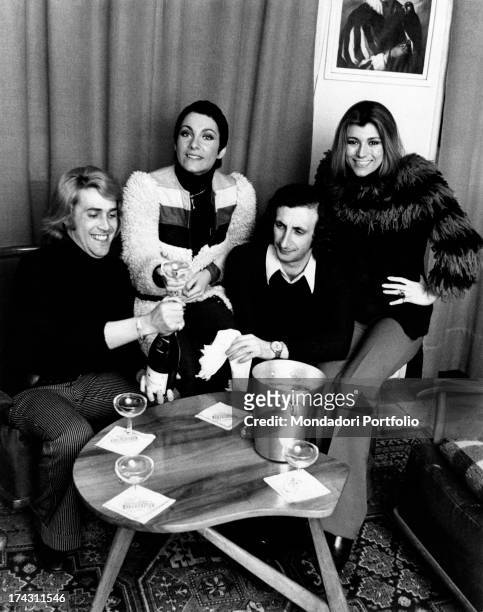Italian singers Marina Occhiena, Angela Brambati, Angelo Sotgiu and Franco Gatti celebrating with a bottle of champagne. They form the band Ricchi e...