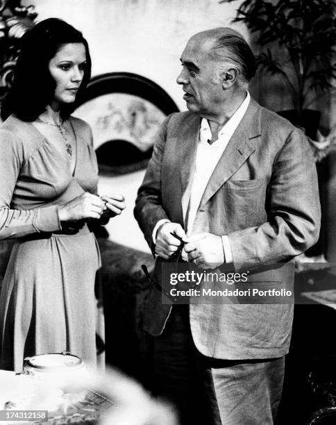 Italian film producer Carlo Ponti talking to Italian actress Agostina Belli in The Governess. Rome, 1974.