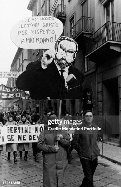 Some Rizzoli-Corriere della Sera workers parading in the streets of the city. One of the protesters holds a sign with the caricature of the President...