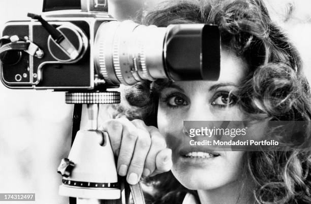 Italian television presenter and actress Gabriella Farinon smiling near a camera. Rome, 1970s.
