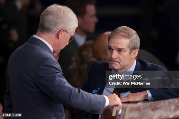 Rep. Jim Jordan talks to Speaker Pro Tempore Rep. Patrick McHenry as the House of Representatives prepares to hold a vote on a new Speaker of the...