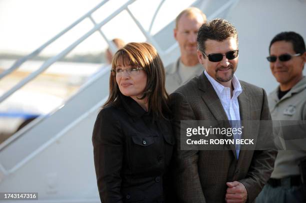 Republican vice-presidential candidate Sarah Palin and her husband Todd Palin prepare to board her campaign plane at the Flagstaff, Arizona airport...