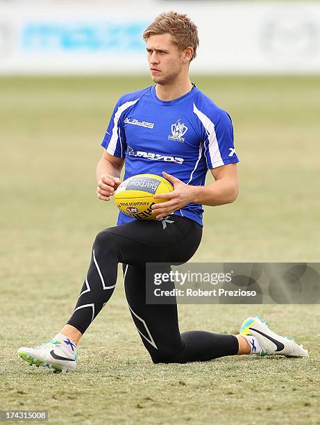 Kieran Harper stretches during a North melbourne Kangaroos AFL media session at Aegis Park on July 24, 2013 in Melbourne, Australia.