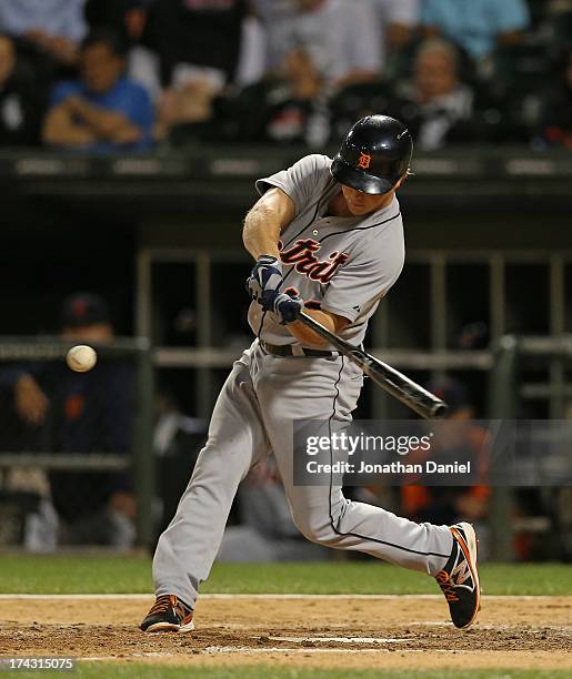 Andy Dirks of the Detroit Tigers hits a single in the 7th inning against the Chicago White Sox at U.S. Cellular Field on July 23, 2013 in Chicago,...