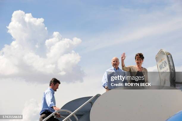 Republican presidential candidate John McCain, his running mate Alaska Governor Sarah Palin and Palin's husband Todd board the campaign airplane in...