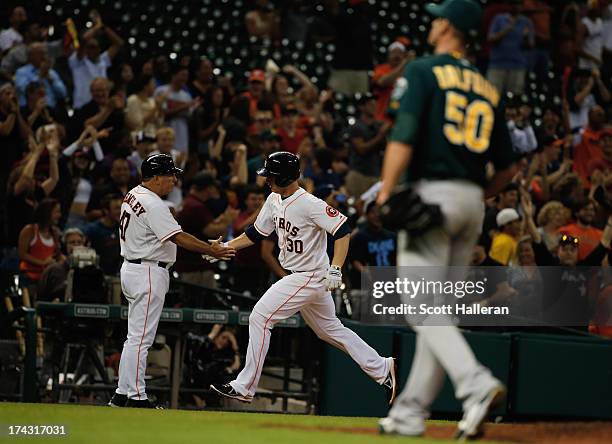 Matt Dominguez of the Houston Astros rounds third base after a two-run home run in the ninth inning off Grant Balfour of the Oakland Athletics at...