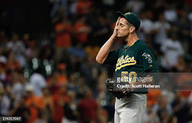 Grant Balfour of the Oakland Athletics reacts to allowing a hit in the ninth inning against the Houston Astros at Minute Maid Park on July 23, 2013...