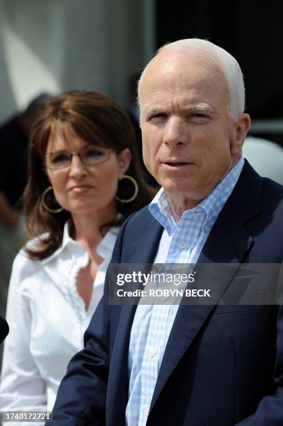 Republican vice-presidential candidate Alaska Governor Sarah Palin listens as her running mate Arizona Sen. John McCain speaks at a press conference...