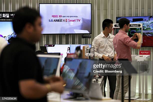 Customers try out LG Electronics Inc. Products at one of the company's bestshop stores in the Gangnam area of Seoul, South Korea, on Wednesday, July...