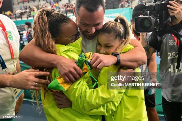 Brazil's Rebeca Andrade and Flavia Saraiva celebrate after winning the silver and bronze medals respectively in the artistic gymnastics women's...