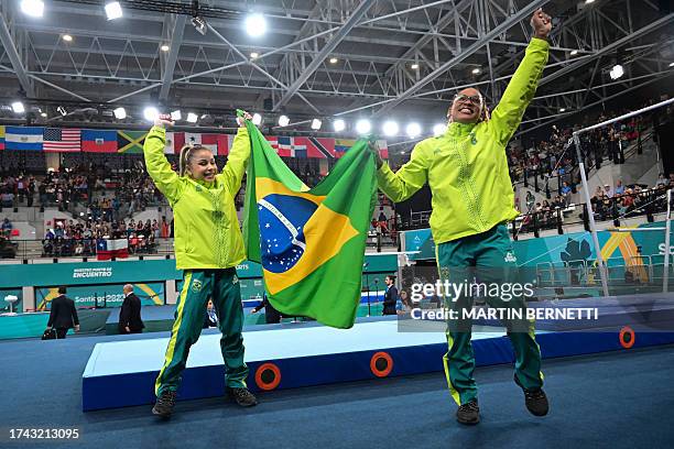 Brazil's Rebeca Andrade and Flavia Saraiva celebrate after winning the silver and bronze medals respectively in the artistic gymnastics women's...