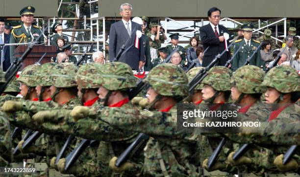 Tokyo Governor Shintaro Ishihara and Eastern Army Lt. General Hirotoshi stand as troops of the Ground Self-Defense Force Eastern Army march during a...